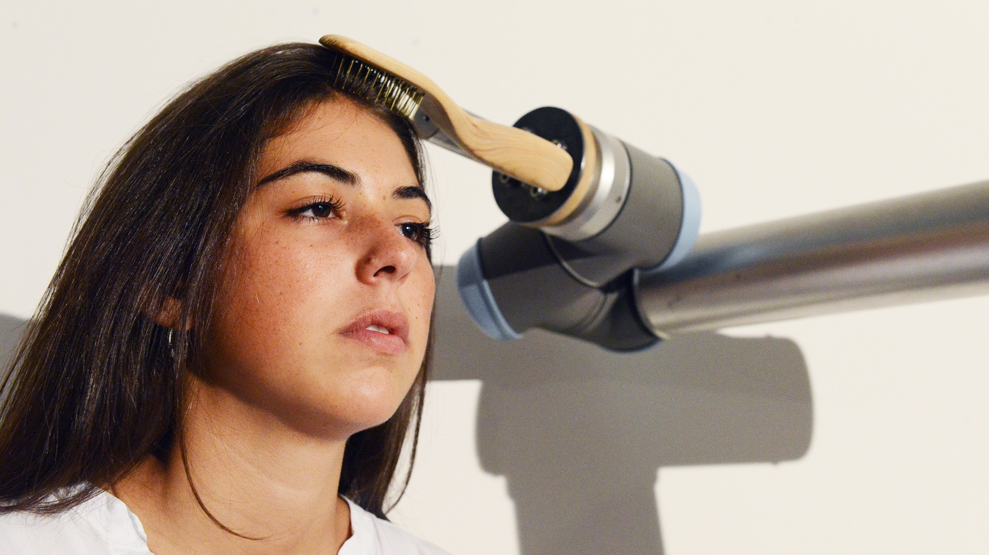 Detail of the robotic arm joint and brush head.