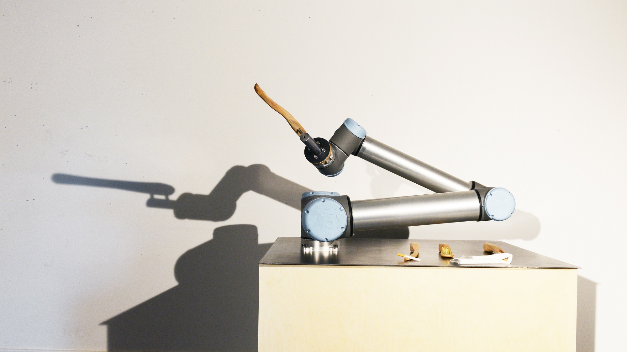 Participant seated, the arm reaching across the frame.